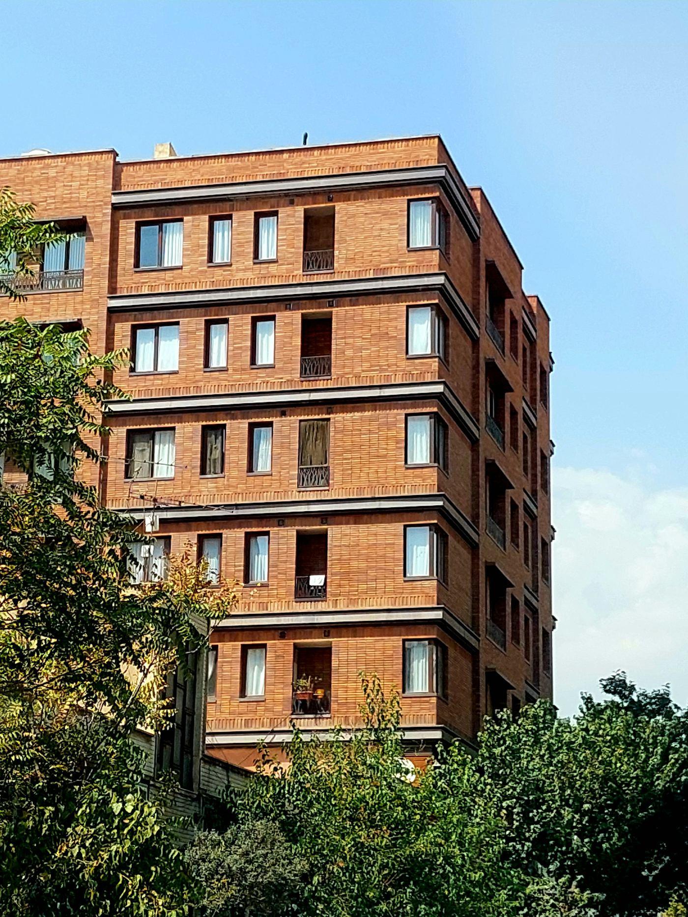 Brick apartment building facade with rows of windows
