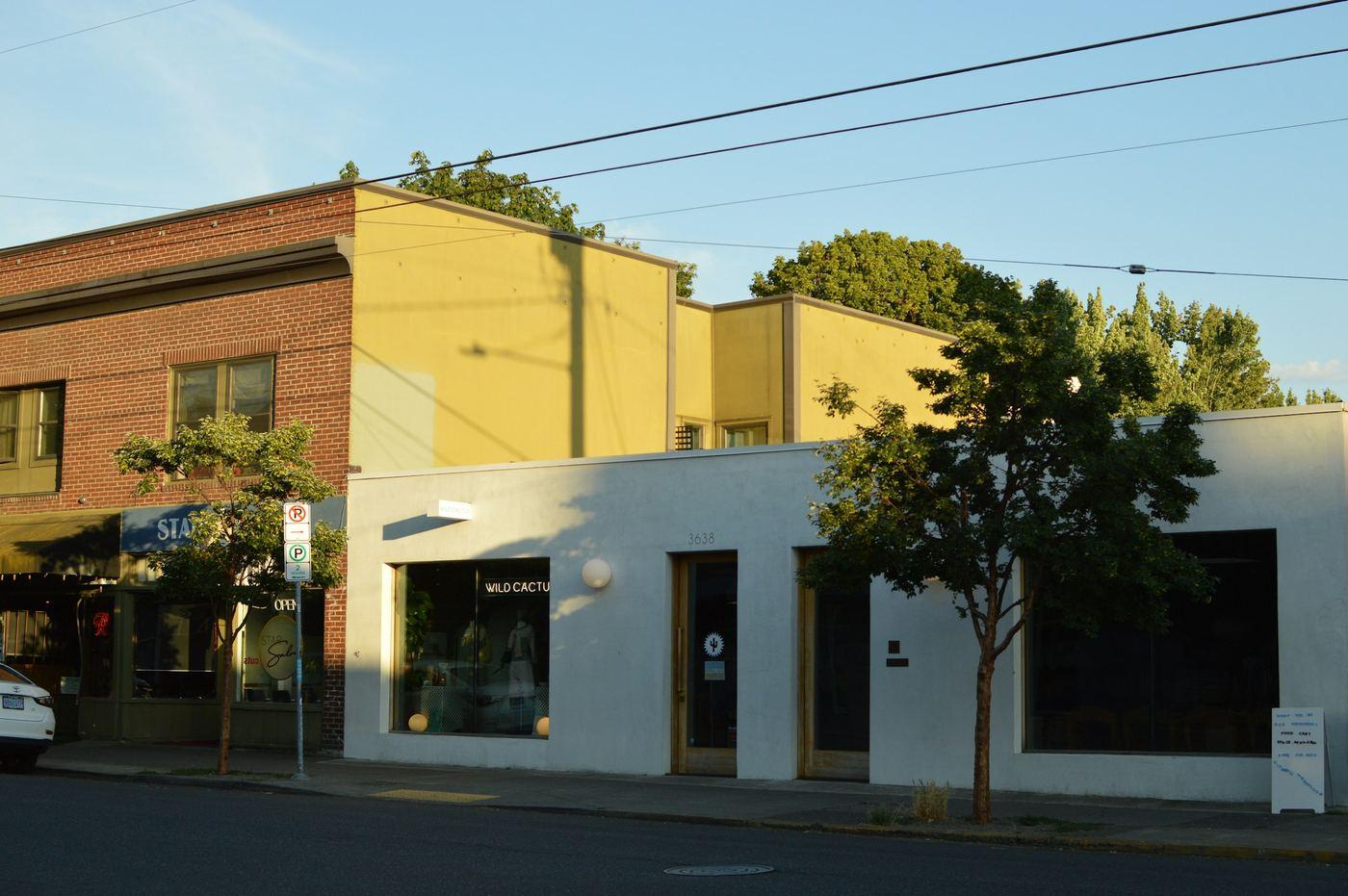 Row of brick commercial storefronts on a main street